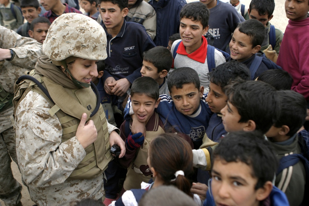 Navy Lt. Rasha Hanna interacts with Iraqi children.