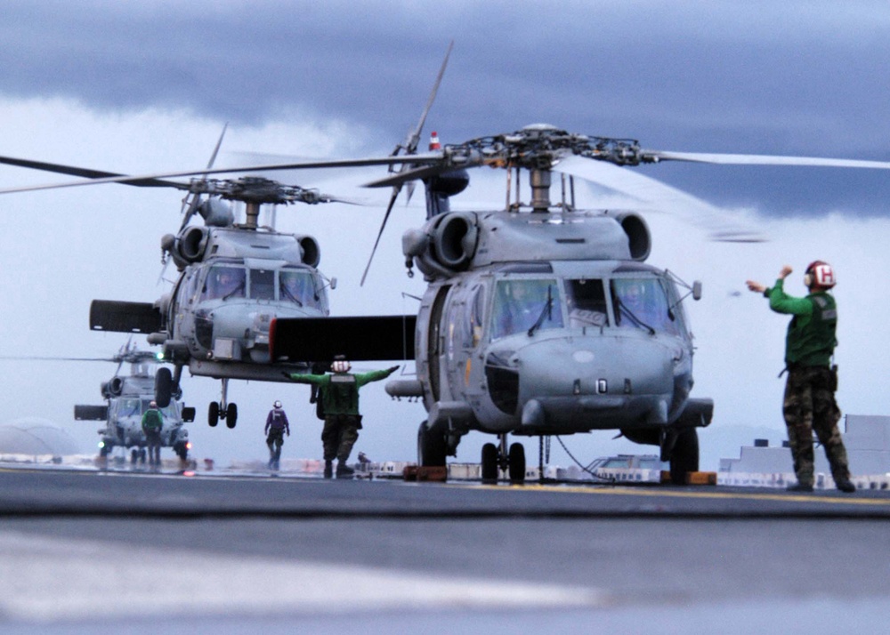Carrier Air Wing 2 helicopters land on USS Abraham Lincoln (CVN 72).