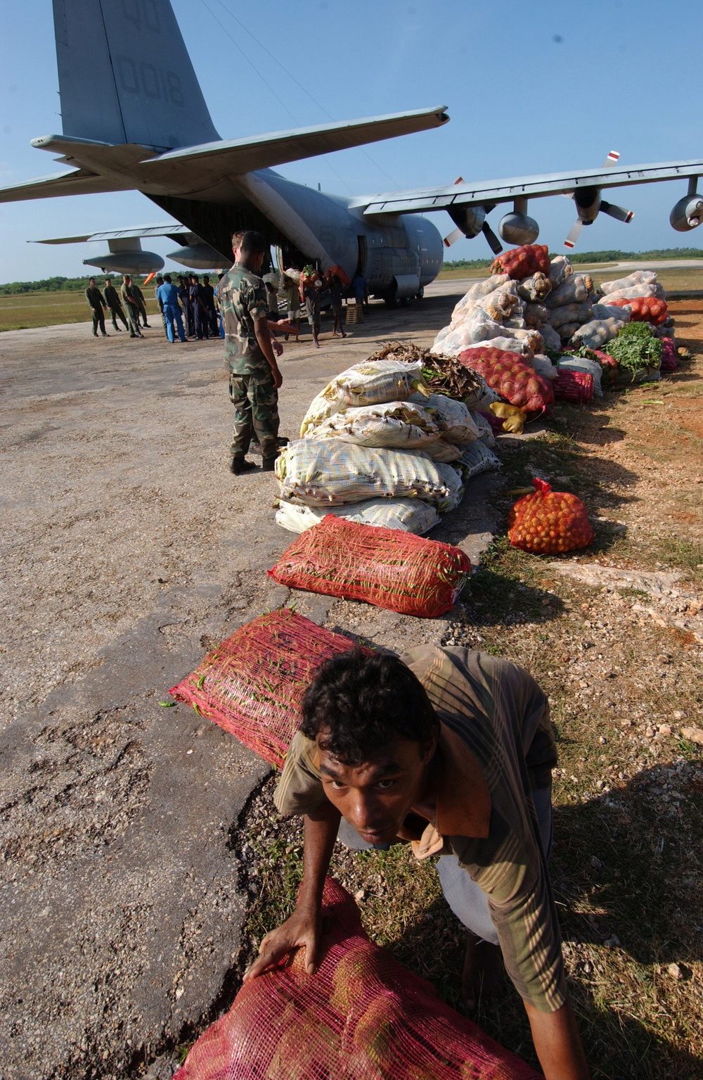 Residents of Jaffna, Sri Lanka, unload bags of vegetables.