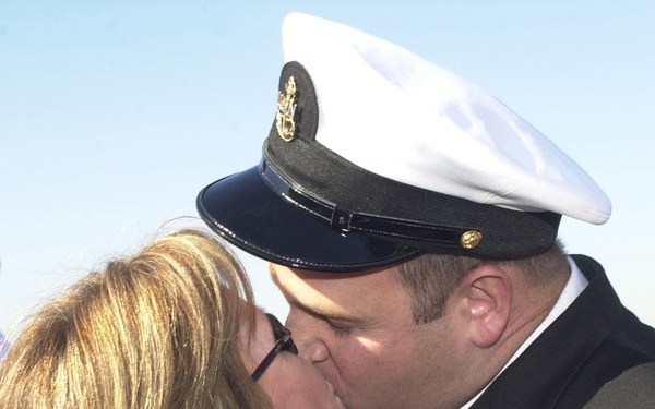 Chief Petty Officer Dominic Brunozzi kisses his wife Diane upon his return.