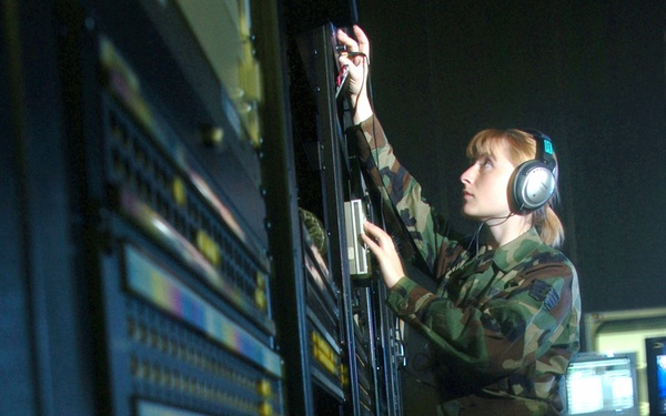 Staff Sgt. Michele Stumm checks the audio output levels of a Scoop Reporter II system.