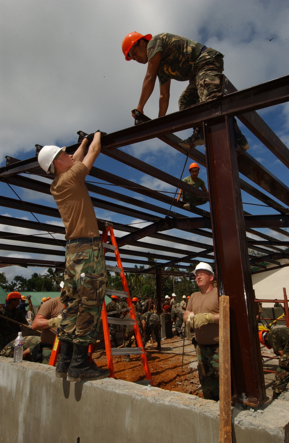 Engineers from the North Dakota Army National Guard erect a metal framework.