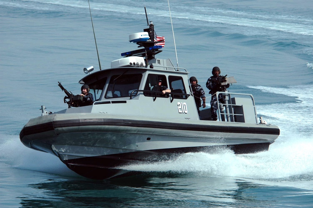 A patrol craft from Inshore Boat Unit 24 makes a hard turn to starboard as the crew conducts a security patrol.