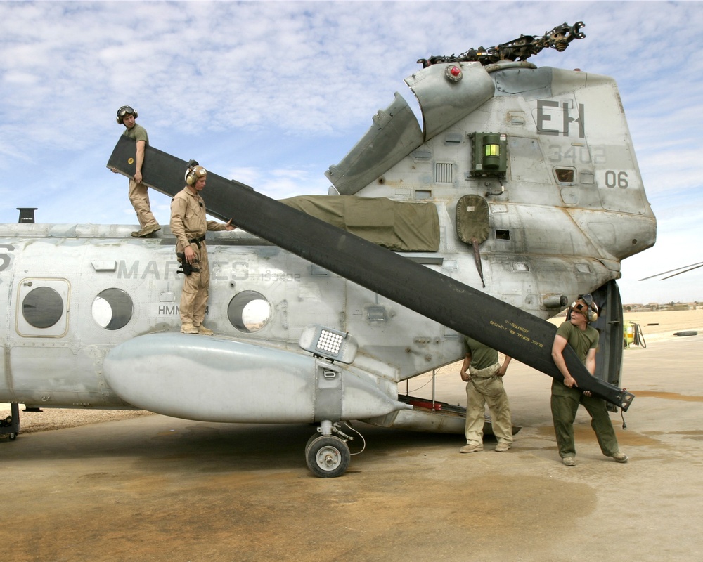 U.S. Marines replace the rotor blades on a CH-46E Sea Knight helicopter.
