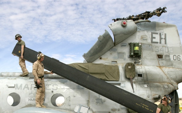 U.S. Marines replace the rotor blades on a CH-46E Sea Knight helicopter.