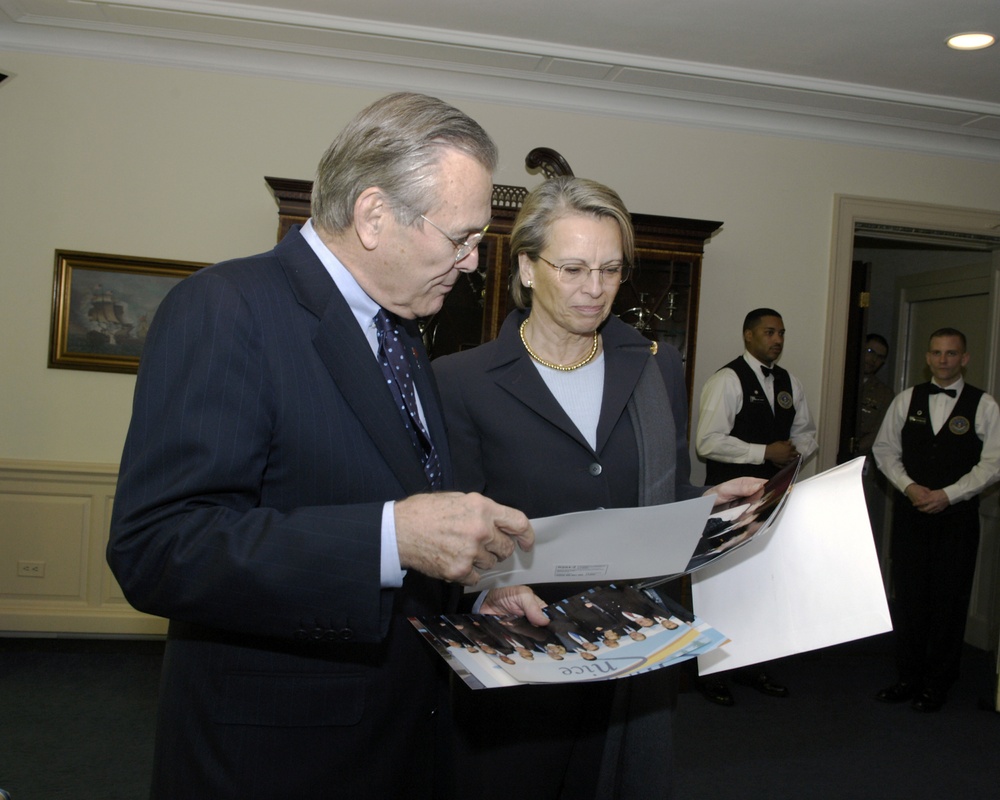 French Minister of Defense Michelle Alliot-Marie presents Secretary Rumsfeld photographs.