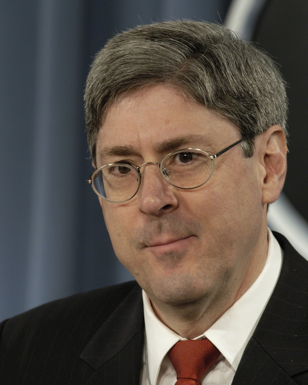 Under Secretary of Defense for Policy Douglas J. Feith listens to a reporter's question.