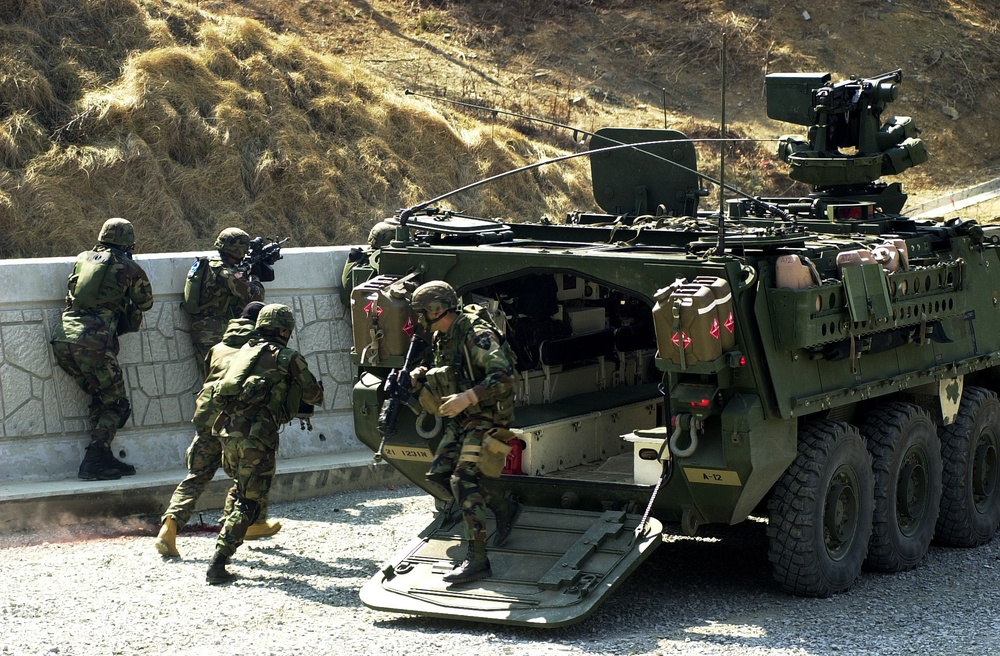 U.S. Army soldiers deploy out of a Stryker Infantry Carrier Vehicle.