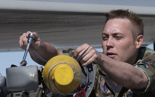 U.S. Air Force Staff Sgt. Ralph Dutterweich takes an AIM 9-X Sidewinder missile off of an F-15 Eagle.