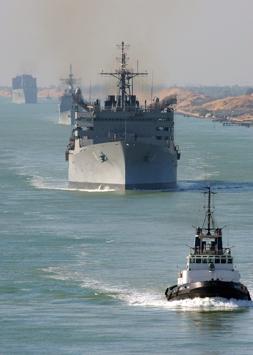 An Egyptian tugboat leads the fast combat support ship USNS Arctic (T-AOE 8).