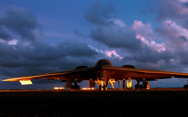 Aircraft mechanics gather on the flight line to pre-flight their B-2 Spirit bomber.