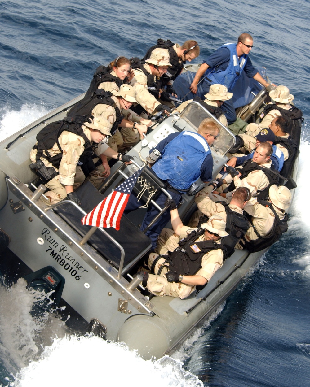 A Maritime Security Operations team pulls away from the guided missile destroyer USS Mustin (DDG 89).