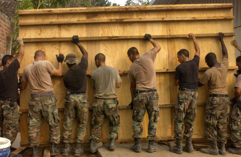 Air Force engineers use a lot of muscle to move a concrete form.