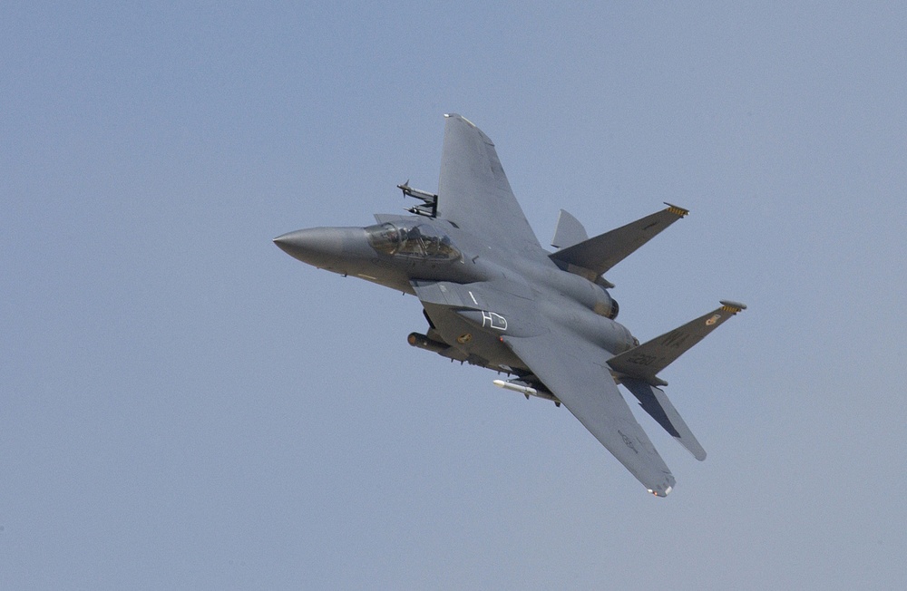 An F-15 Eagle fighter makes a high speed pass during a firepower demonstration.