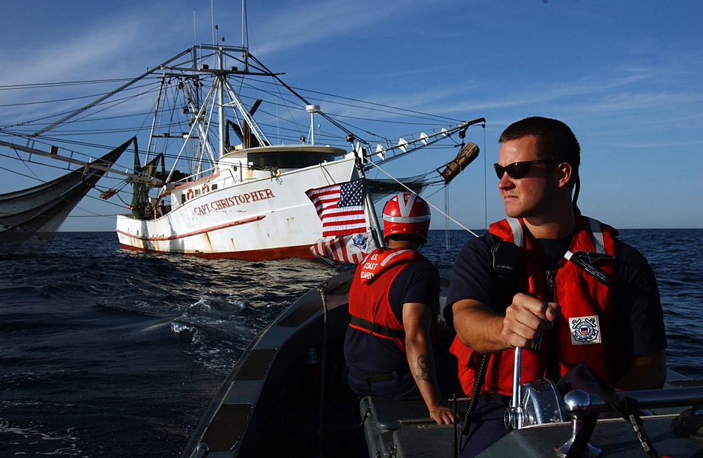 U.S. Coast Guard Petty Officer 2nd Class Karl Munson pilots a 26-foot boat.