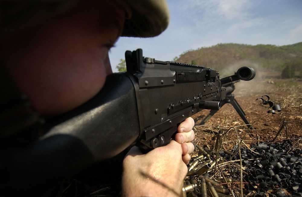 Marine Sgt. Will Edwards sites in an M240G medium machine gun.