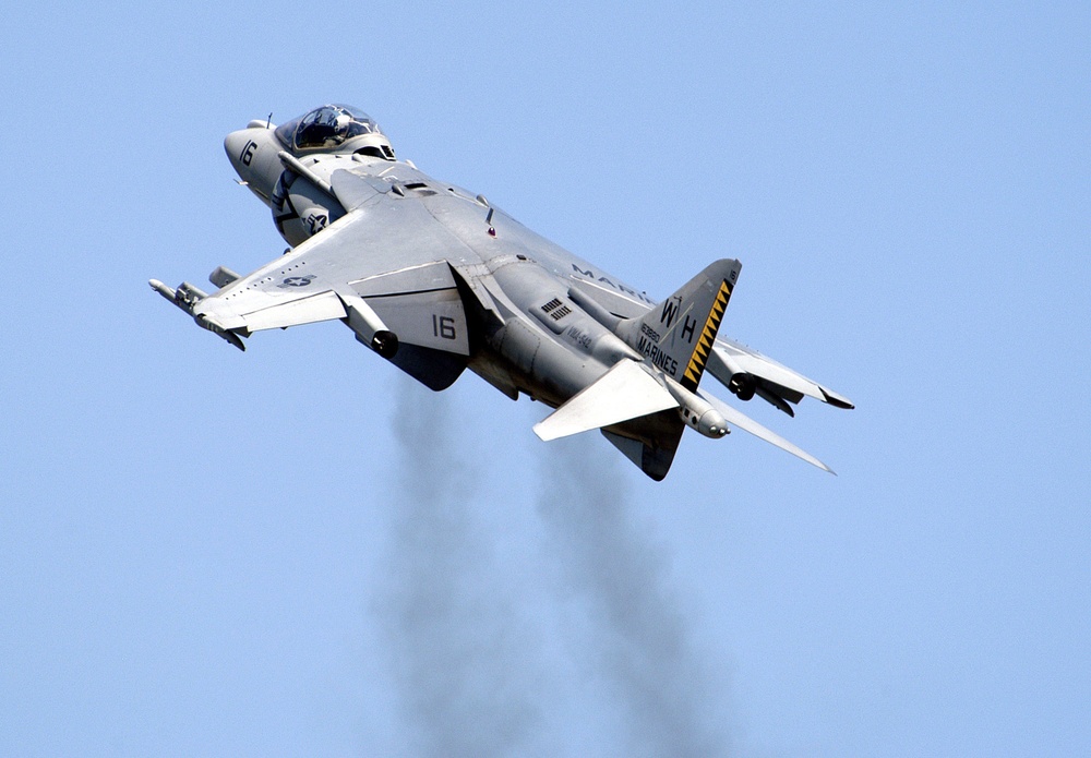 An AV-8B Harrier II takes off nearly vertical during a flight demonstration.