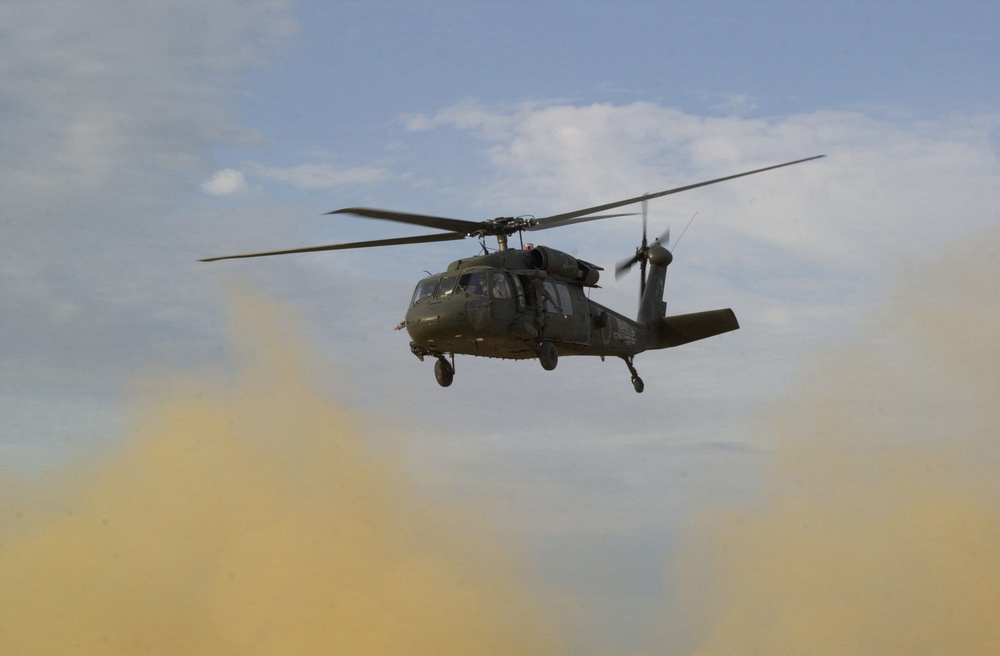 A UH-60 Blackhawk helicopter takes off after delivering supplies.