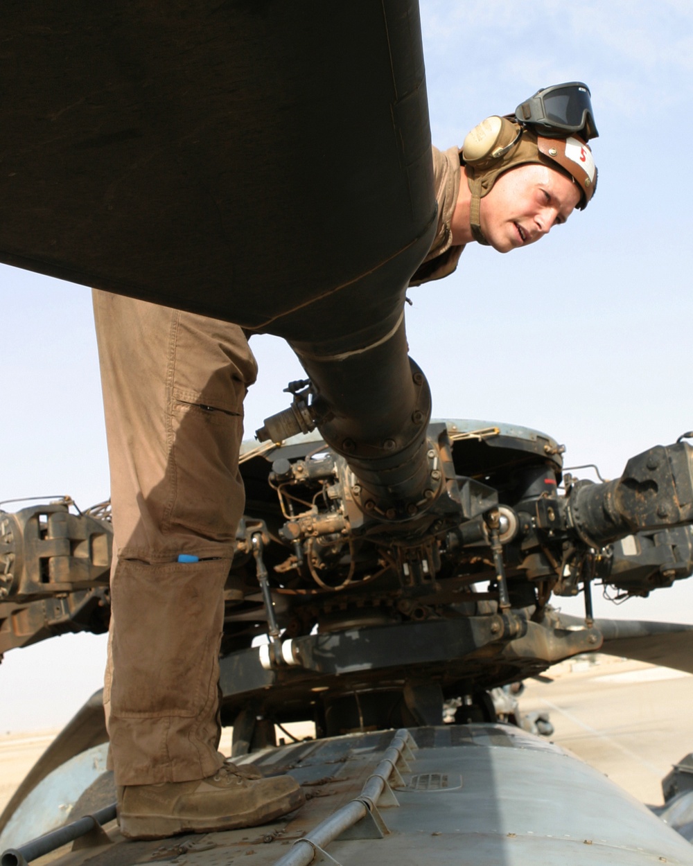 U.S. Marine Sgt. Timothy Hale performs a preflight inspection on a CH-53 Super Stallion helicopter.