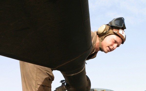 U.S. Marine Sgt. Timothy Hale performs a preflight inspection on a CH-53 Super Stallion helicopter.