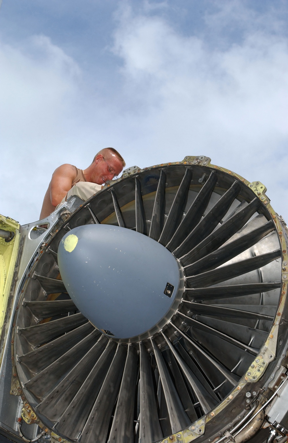 Air Force Staff Sgt. Benjamin Davis removes a nose cowl of an engine on a B-52 Stratofortress.