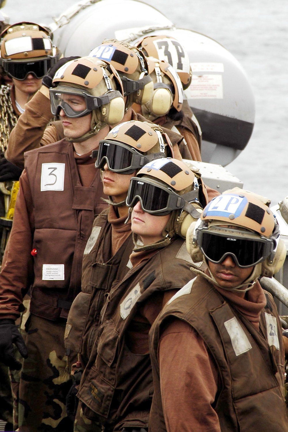 Plane captains watch flight operations from the catwalk.