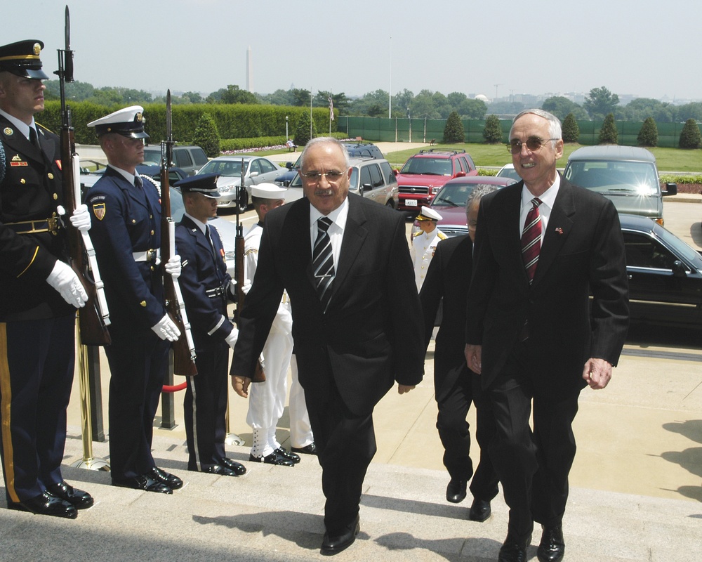 Turkey's Minister of National Defense Vecdi Gonul is escorted into the Pentagon by Acting Deputy Secretary England.