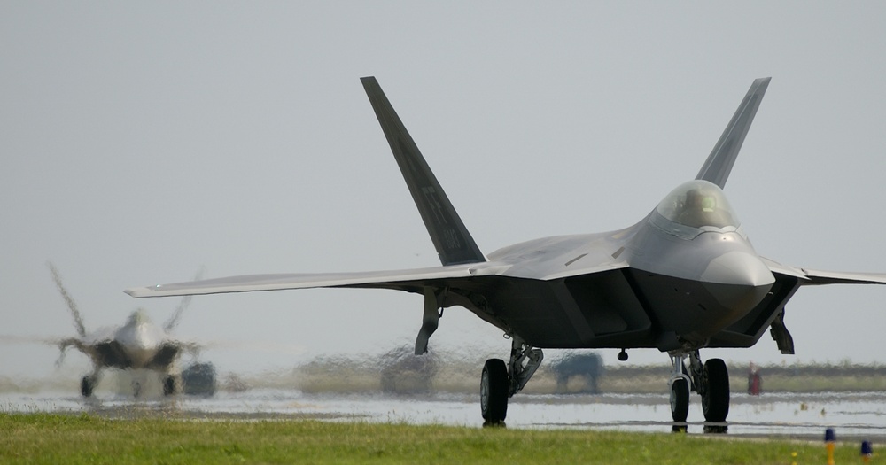 Two F/A-22 Raptor aircraft taxi down the runway at Langley Air Force Base, Va.