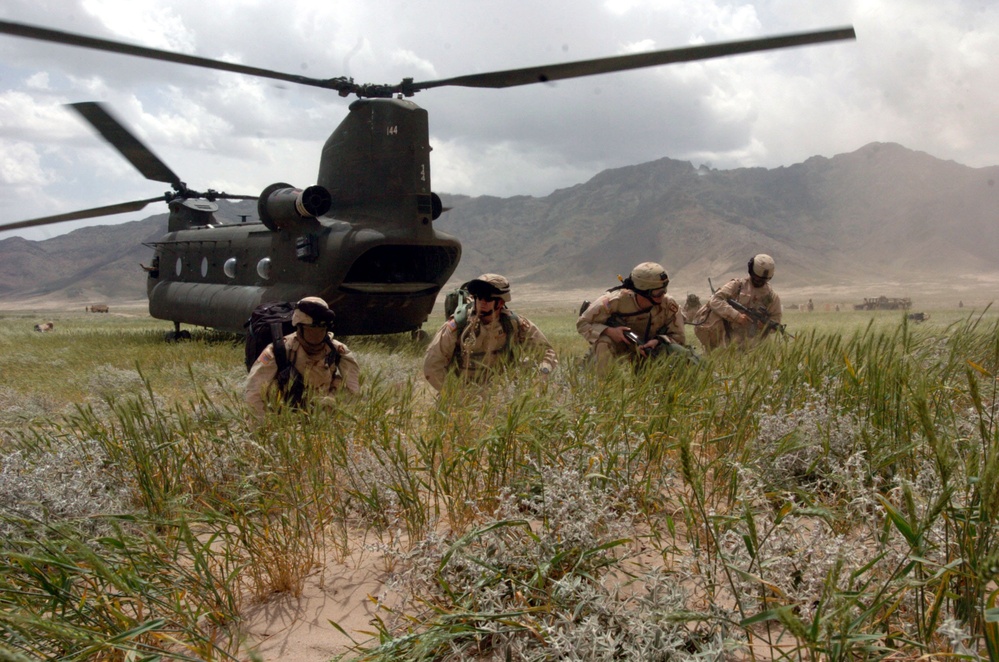 Soldiers establish a security perimeter after exiting a U.S. Army CH-47 Chinook helicopter.