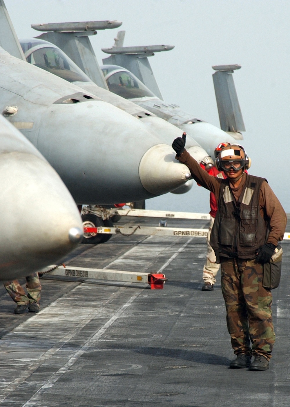 A Plane Captain gives a thumbs up.