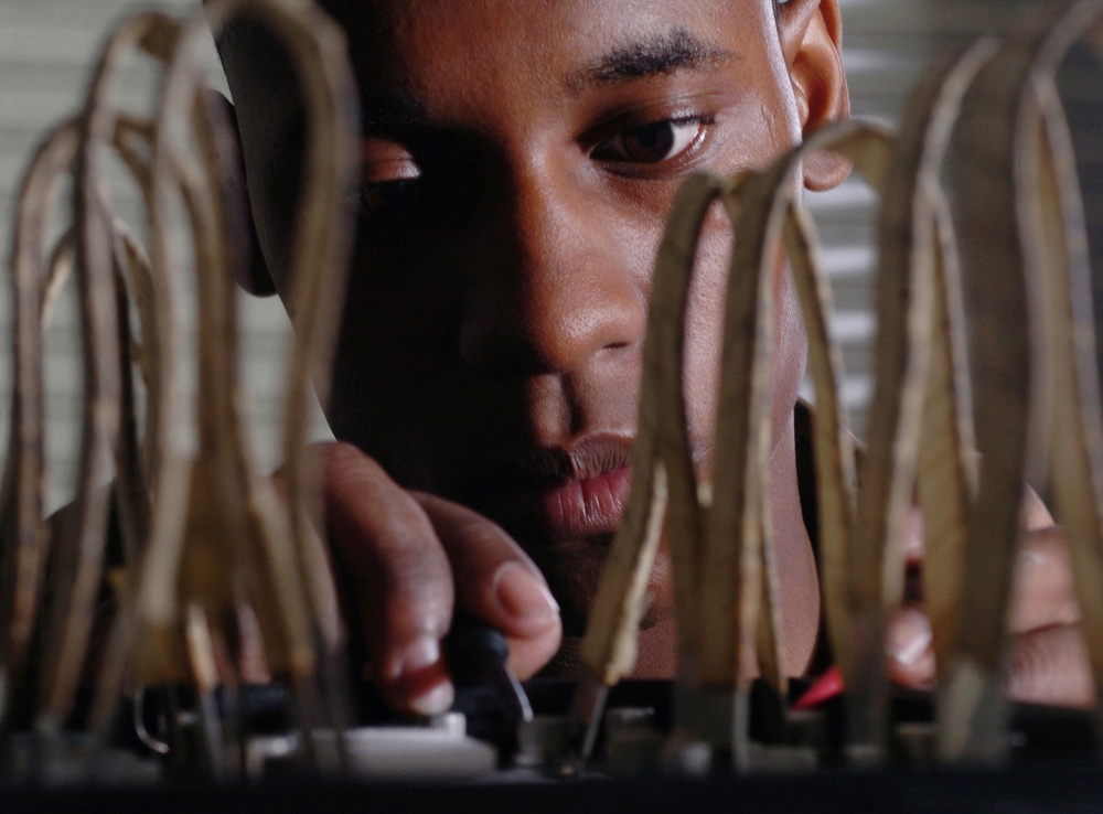 Airman 1st Class Chad Bowen inspects C-17 Globemaster III aircraft instrumentation and navigation systems batteries.