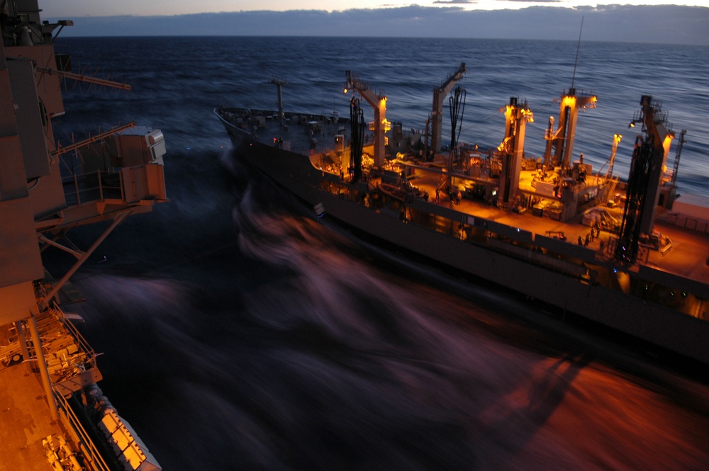 The oiler USNS Guadalupe pulls alongside the aircraft carrier USS Kitty Hawk.