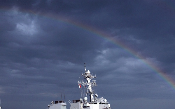 A rainbow arches over the guided missile destroyer USS Gonzalez (DDG 66)