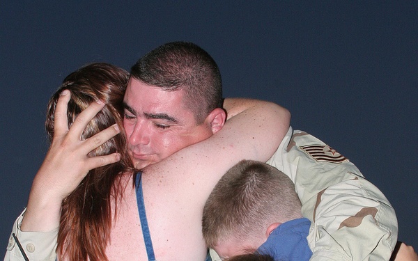 Air Force Tech. Sgt. Rick Bouwhuis is embraced by his family.