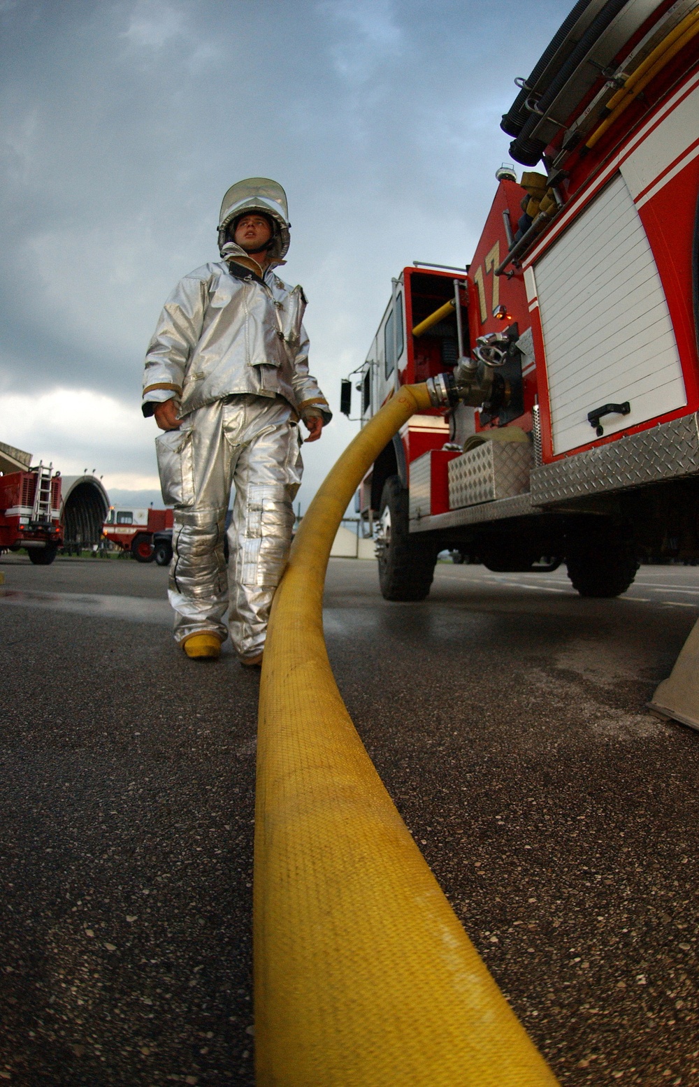 Air Force Senior Airman Jason McMillon stands by his fire truck.