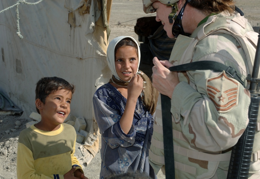 U.S. Air Force Master Sgt. Jennifer Smith talks with two Bedouin children.