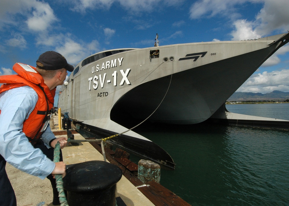 Navy Petty Officer 3rd Class Erik Horner casts off a mooring line.