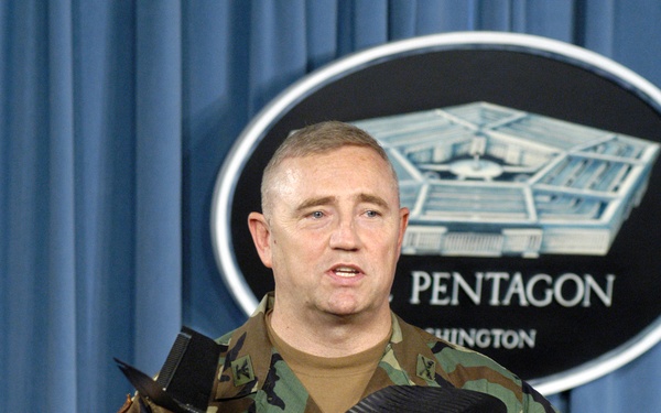 Col. Gregory N. Tubbs shows reporters a small, man-portable, remotely controlled, reconnaissance aircraft.