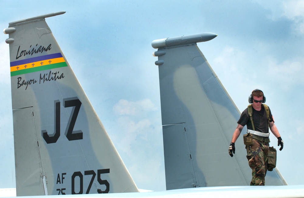 A Louisiana Air National Guardsman inspects the fuselage of a F-15 Eagle aircraft.