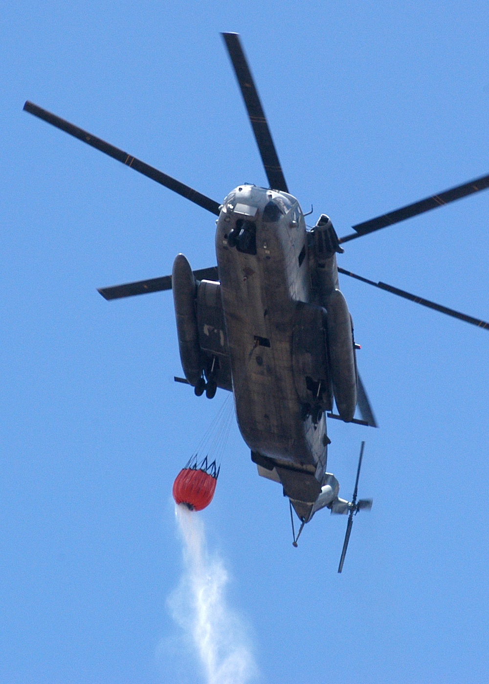 A U.S. Marine Corps CH-53E Super Stallion helicopter prepares to drop more than 2,000 gallons of water.