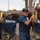 U.S. Navy sailors and Mexican Marines carry a log as they remove Hurricane Katrina debris.