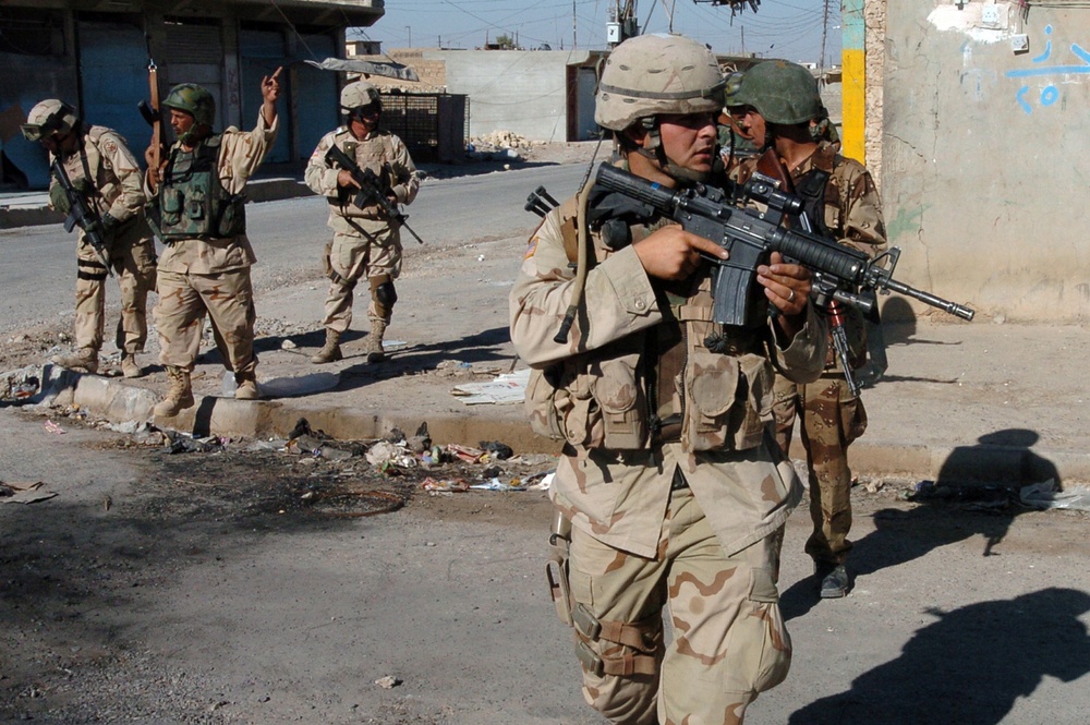 U.S. Army and Iraqi soldiers cross an intersection during a routine security patrol in downtown Tal Afar, Iraq.