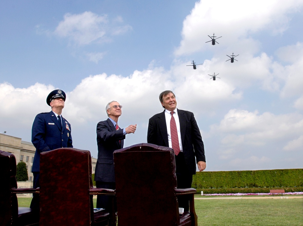 Gen. Myers, Acing Deputy Secretary England, and Rep. Duncan Hunter watch the fly-over of helicopters and jet aircraft.