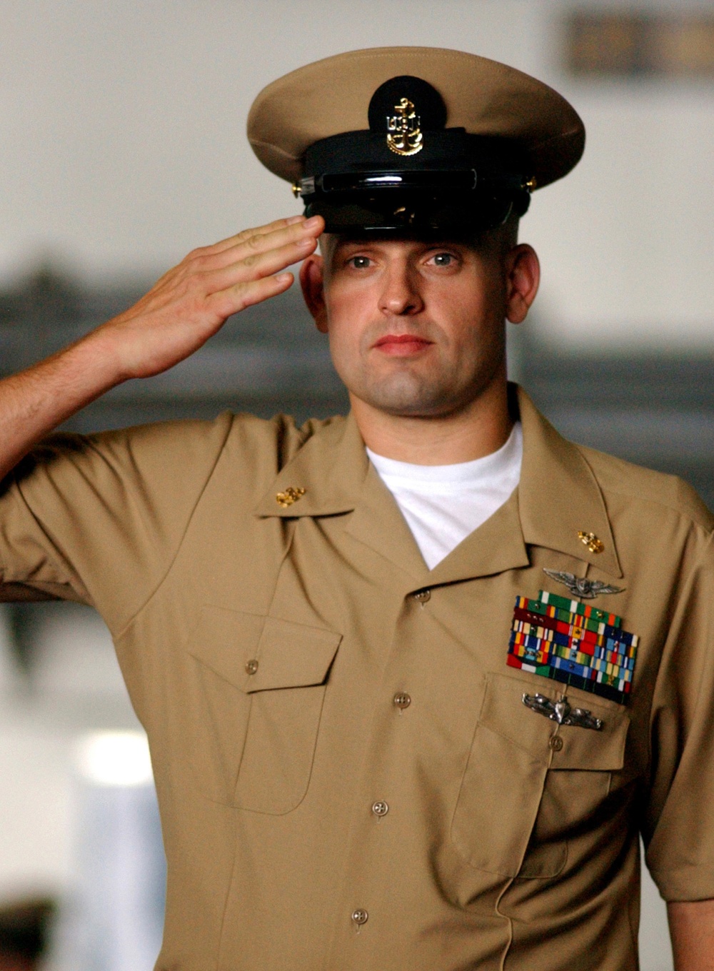 Newly pinned U.S. Navy Chief Petty Officer John Vincent salutes.