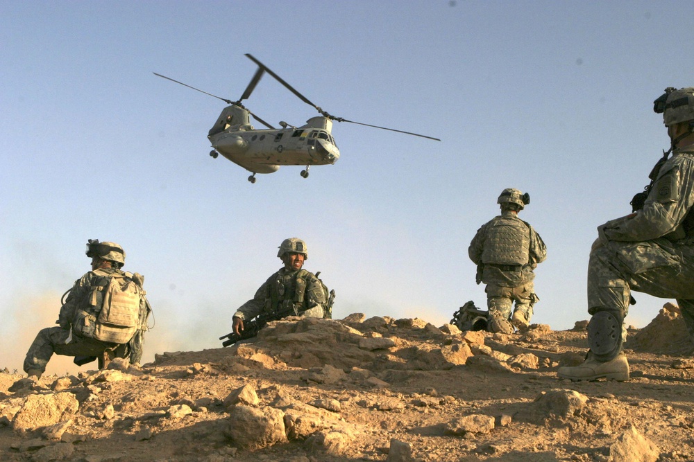 U.S. Army soldiers set up a security perimeter after landing in the desert.