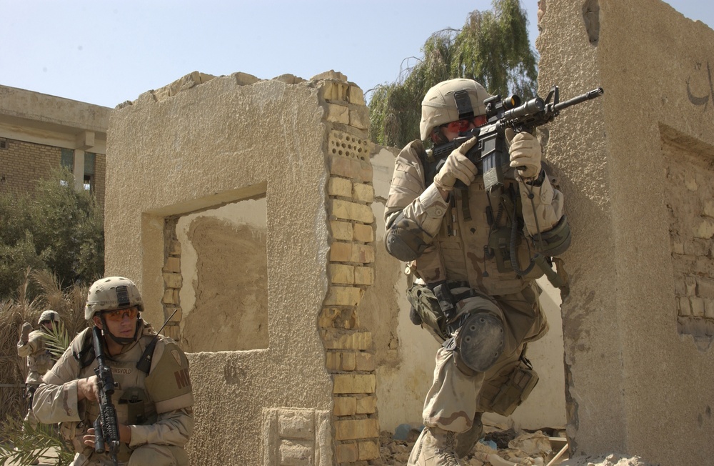 U.S. Army soldiers react to small arms fire.