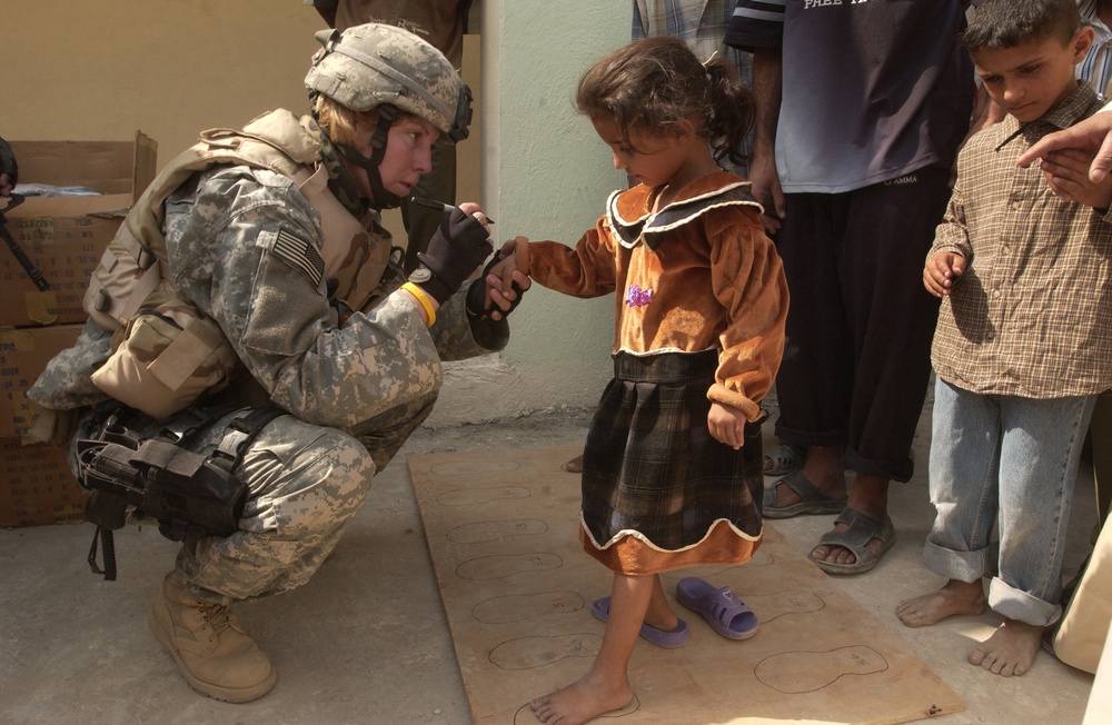 An Iraqi girl gets her feet measured for a new pair of shoes.