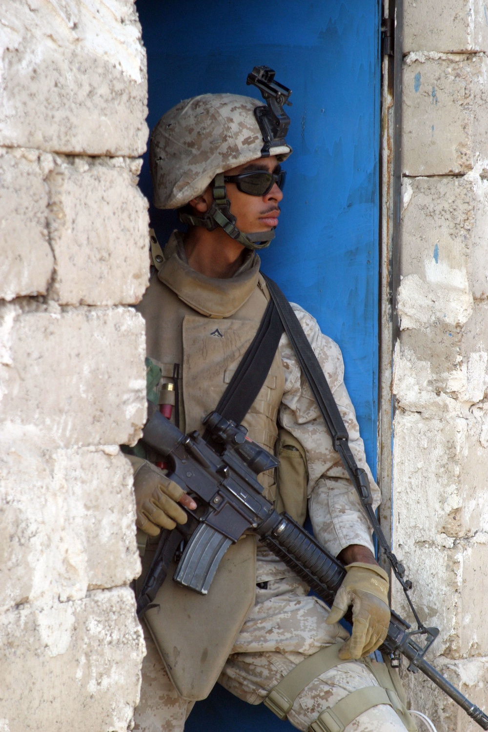 U.S. Marine Corps Lance Cpl. Hector Figueroa takes up a position in a doorway.