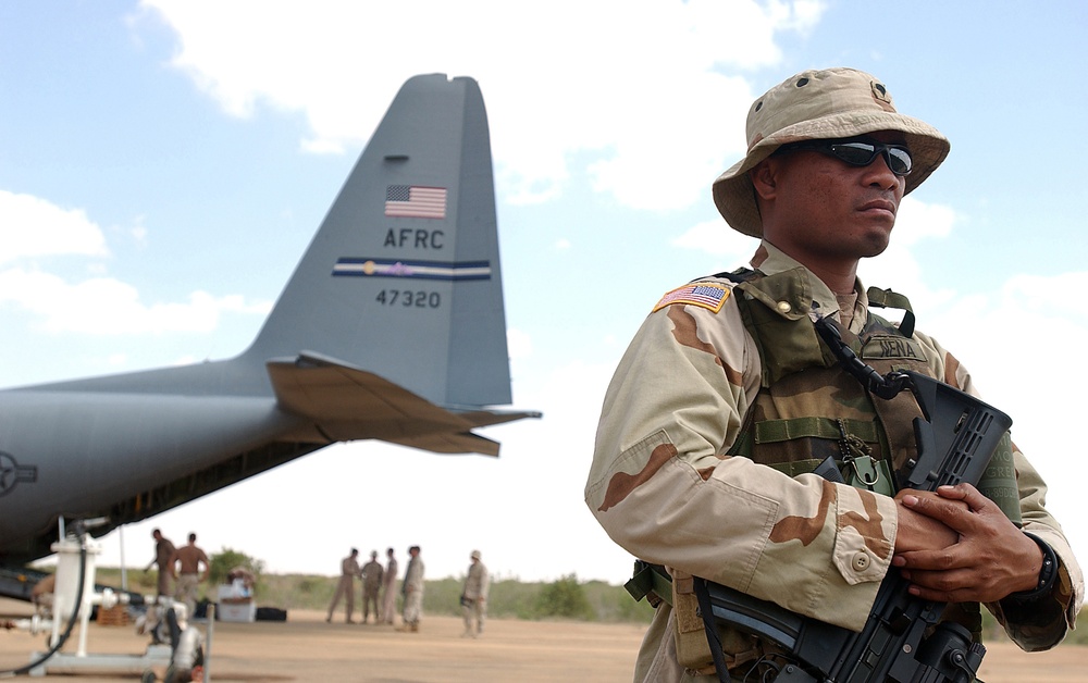 Army Spc. Tulen Nena stands guard on the flight line.