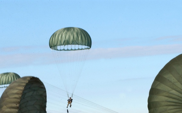 A Navy SEAL tries to steer clear of surrounding parachutes as he parachutes into the Gulf of Mexico.
